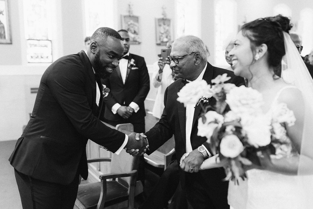 Groom shakes father of bride's hand