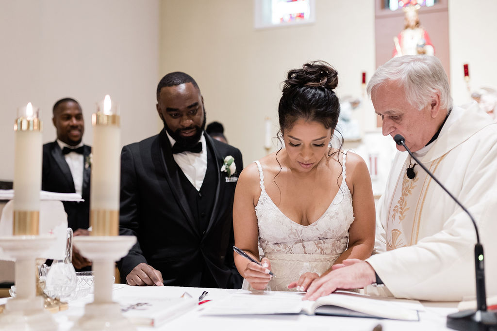 Bride signing marriage document