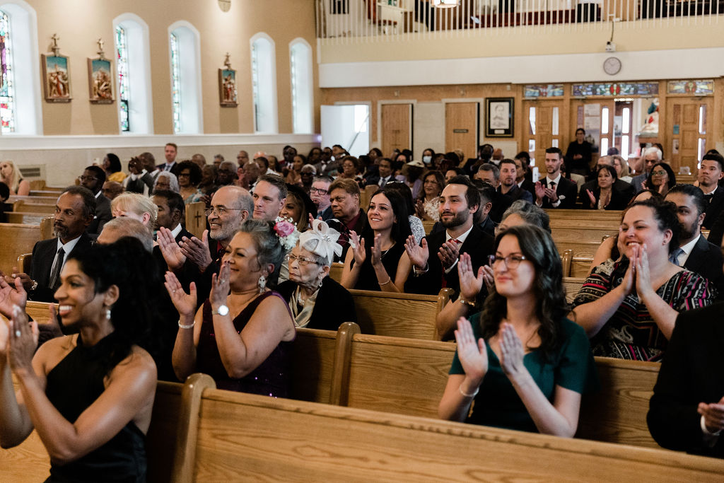 Wedding guests clapping at the union of marriage