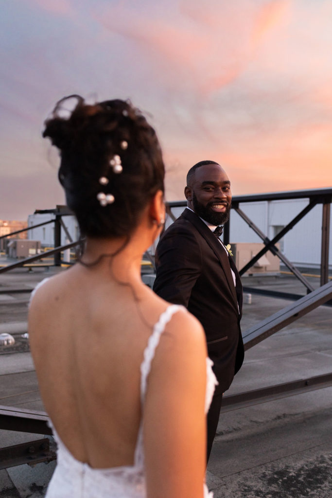 Bride and groom on rooftop of Eglinton West Gallery with sunset